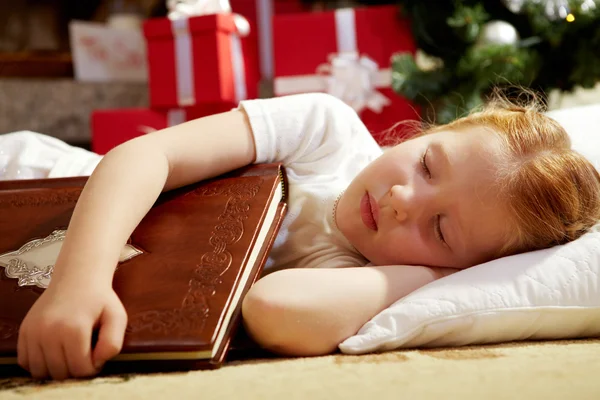 Cute girl falling asleep with book — Stockfoto