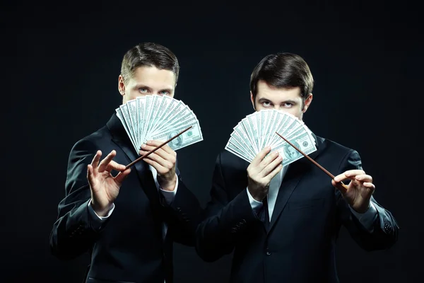 Men with dollar banknotes and wands — Stock Photo, Image