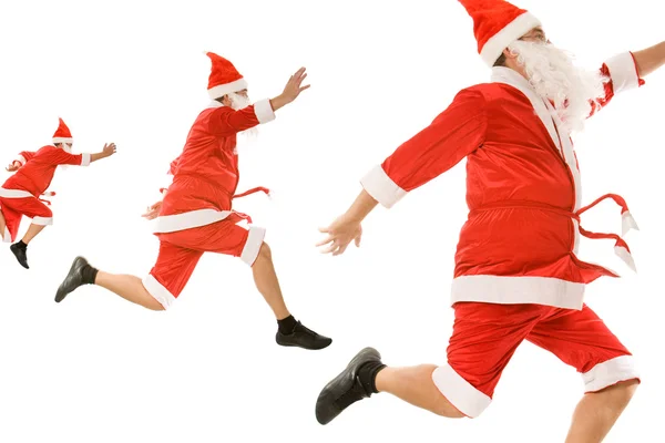 Tres cláusulas de Santa apresurándose para Navidad — Foto de Stock