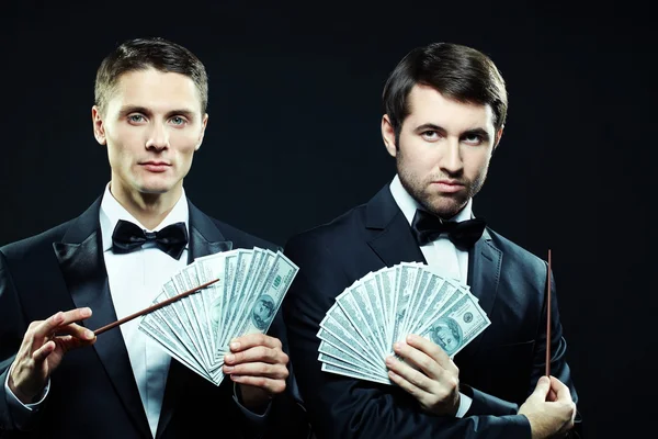 Serious men showing dollar banknotes — Stock Photo, Image