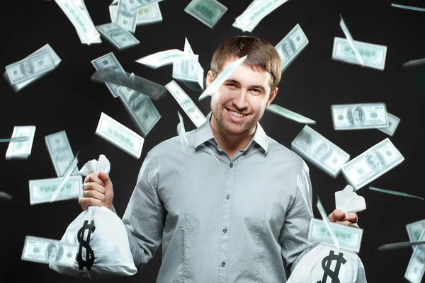 Hombre feliz sosteniendo bolsas de dinero —  Fotos de Stock