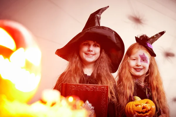 Cute witches by shining Jack o-Lantern — Stock Photo, Image