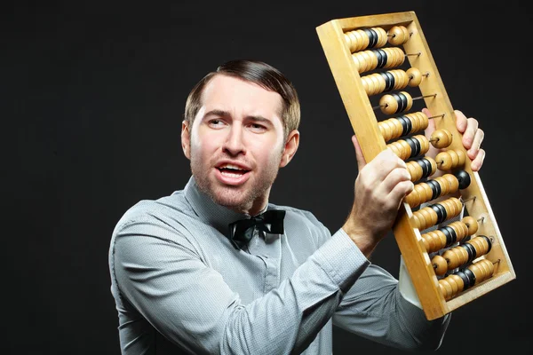 Aggravated businessman holding an abacus — Stock Photo, Image