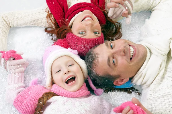 Loving family laughing on snow Stock Picture