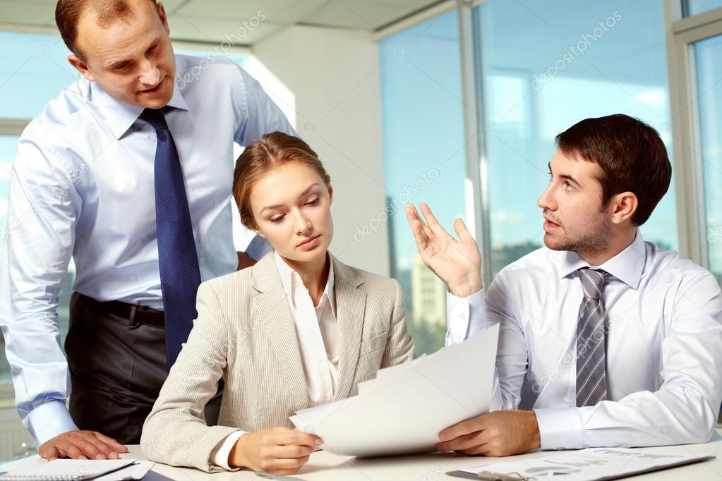Business team discussing papers