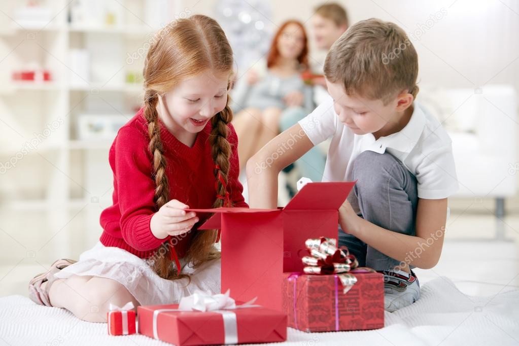 Children taking something out of gift box — Stock Photo © pressmaster