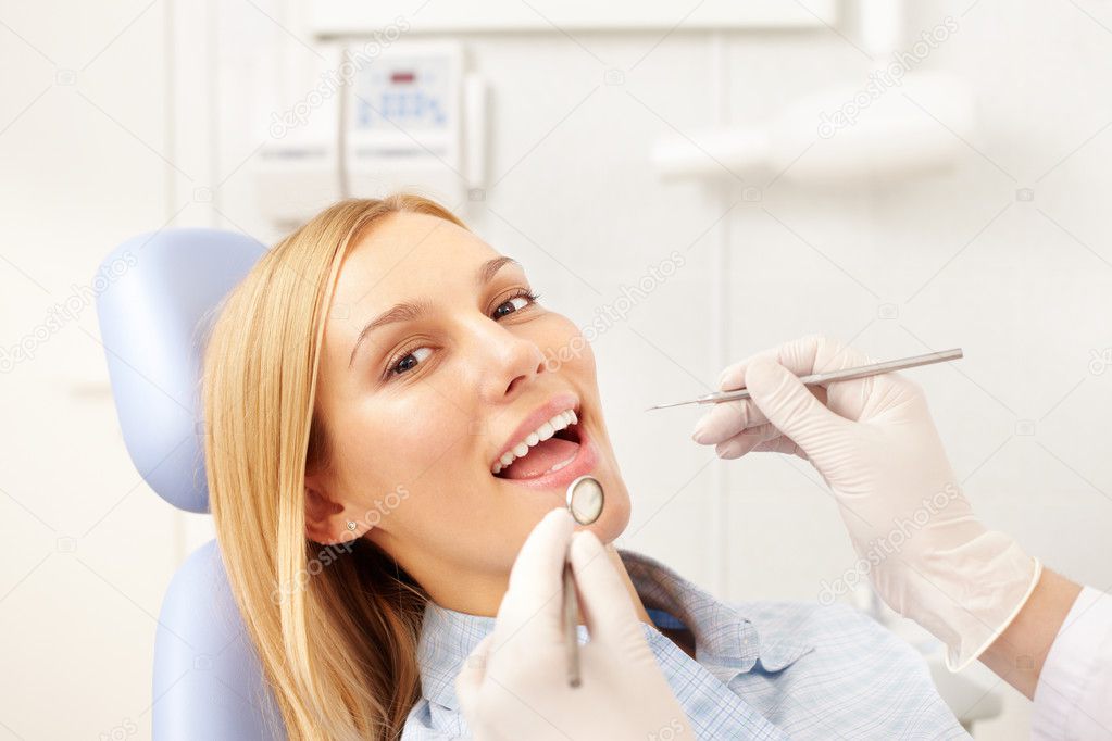 woman being examined by dentist