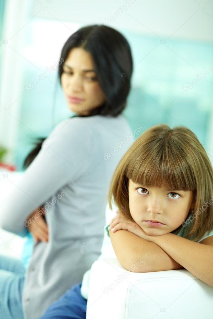 Little girl pouting at her mother 