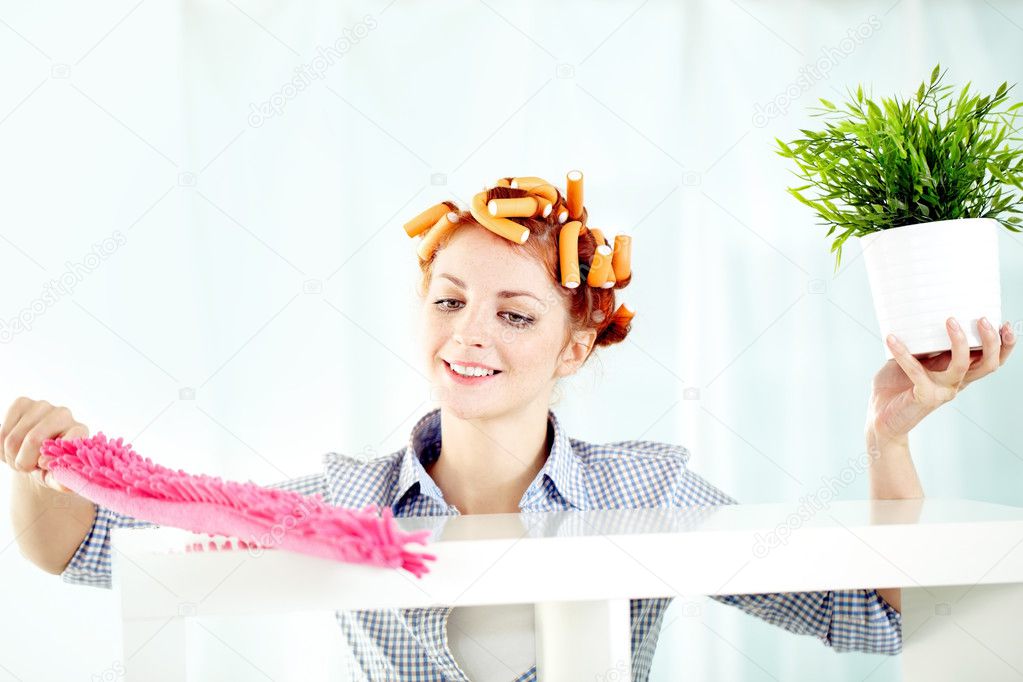 woman cleaning shelves with a brush