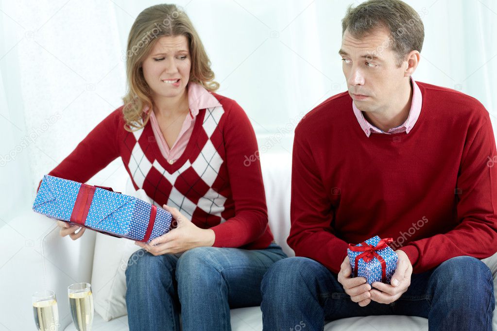 Displeased couple with gift boxes 