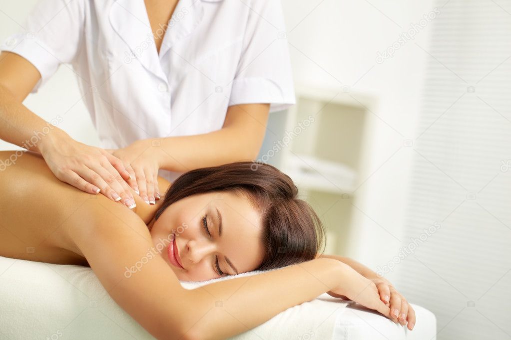 Young woman enjoying spinal massage 