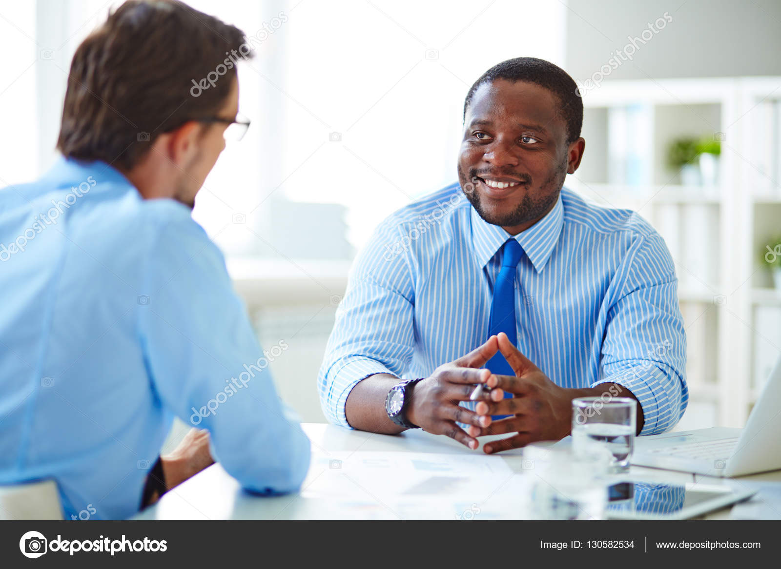 Young businessman sitting at job interview Stock Photo by ©pressmaster