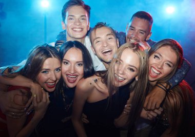 Group of friends laughing at party 
