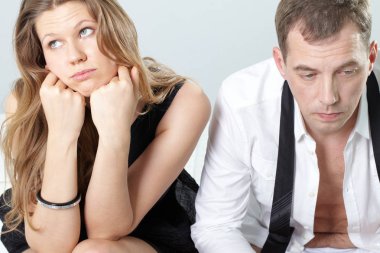 couple sitting together displeased  clipart
