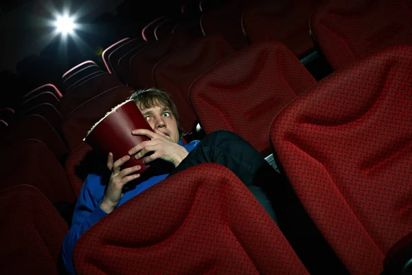 Young man sitting terrified — Stock Photo, Image