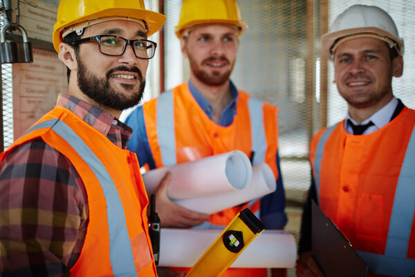 Group of builders in helmets