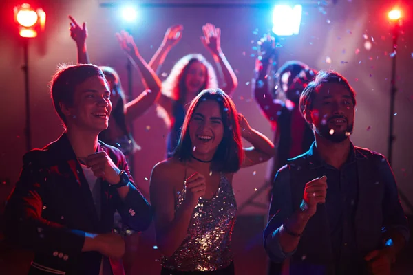 Girl and two guys dancing at the disco — Stock Photo, Image