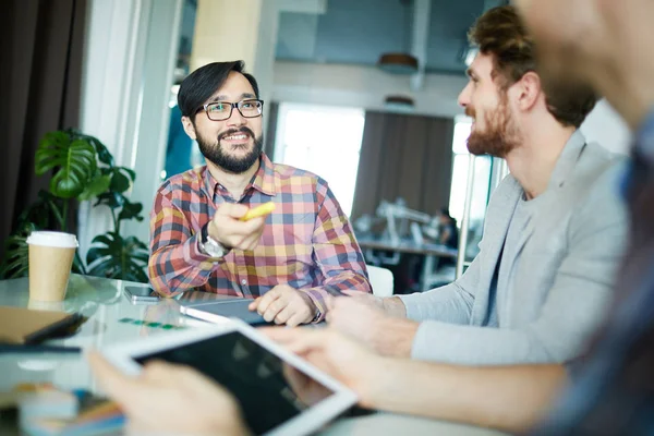 Young designer consulting with colleagues — Stock Photo, Image