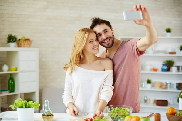 Man and woman making selfie in the kitchen — Stock Photo, Image