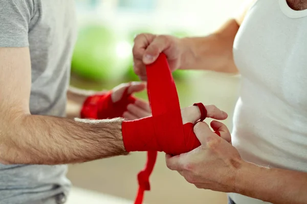 Wrapping wrists of a man before training — Stock Photo, Image