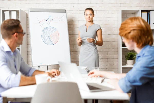 Coach standing by whiteboard during presentation — Stock Photo, Image