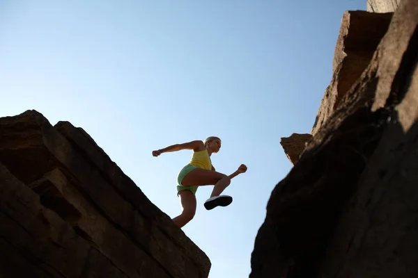 Девушка прыгает в горы — стоковое фото