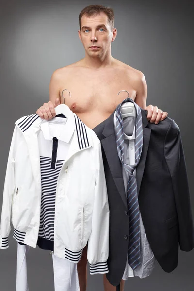 Bachelor holding clothes at morning — Stock Photo, Image