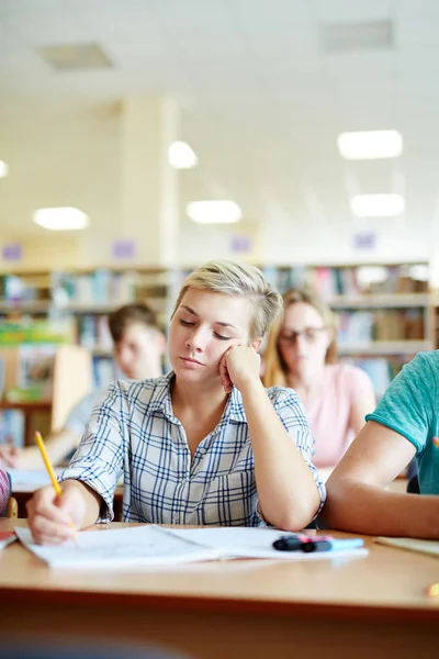 Student writing essay at lesson — Stock Photo, Image