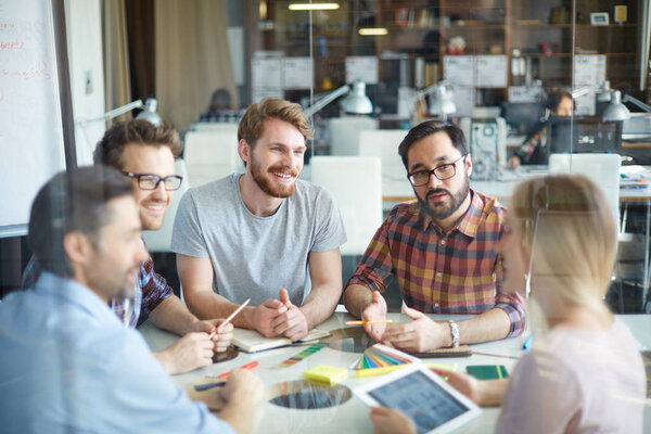 Confident employees having discussion of ideas 