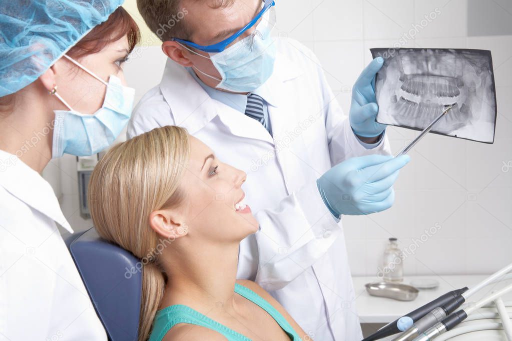 dentist showing a patient teeth x-ray