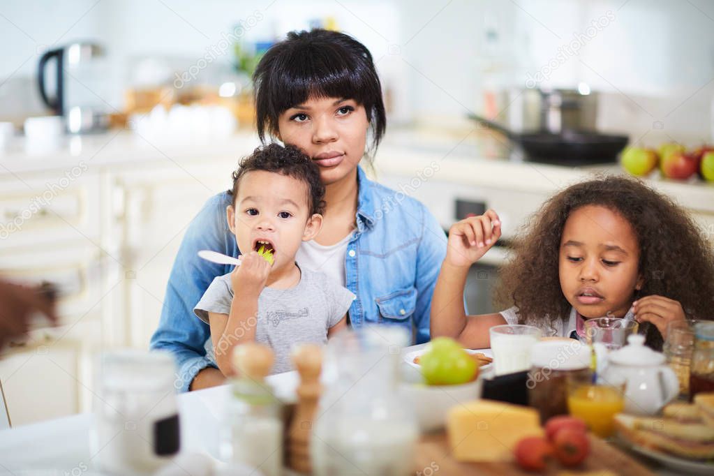 family having breakfast in kitchen