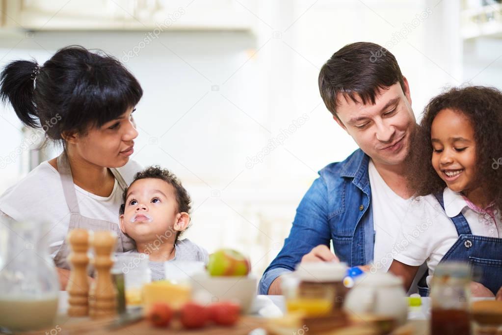 family having breakfast in kitchen