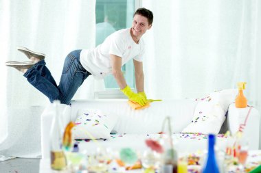 man putting room in order after party clipart