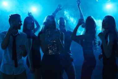 Happy friends dancing in disco lights clipart