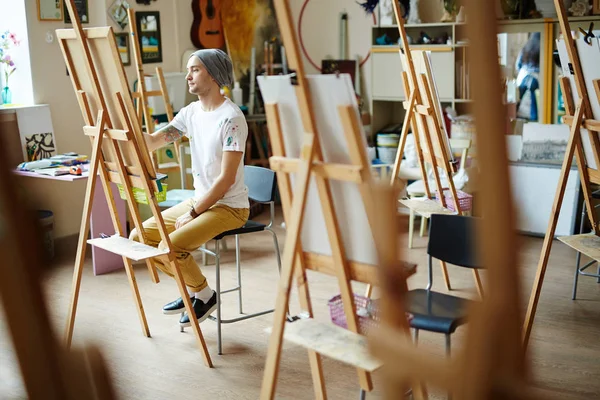 man learning to paint in art-school