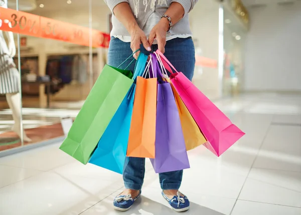 Paper bags held by female shopper — Stock Photo, Image