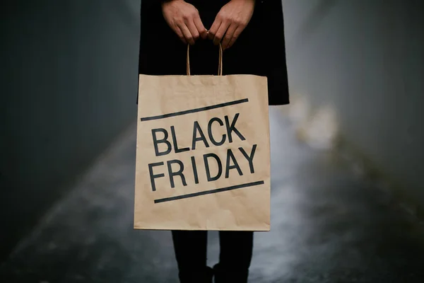 Girl with Blackc Friday shopping bag — Stock Photo, Image