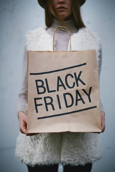 Buyer holding Black Friday bag — Stock Photo, Image