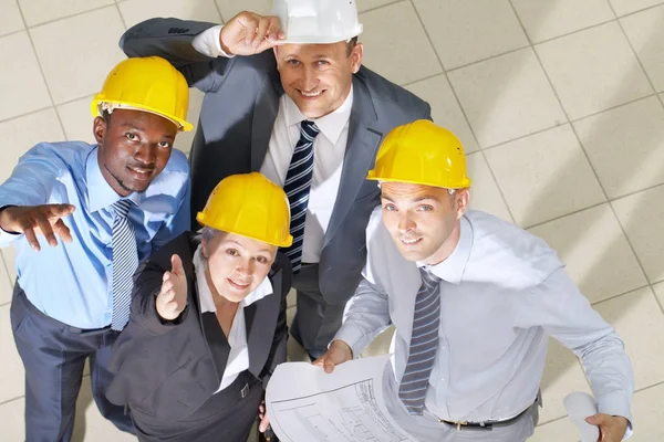 Engineers looking up and smiling — Stock Photo, Image