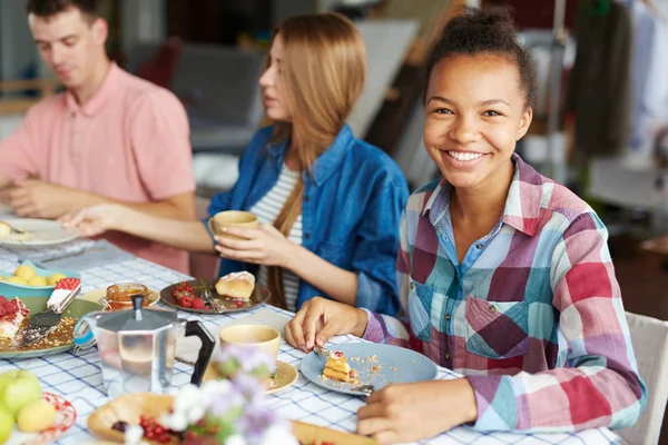 Friendly girl by festive table — Stock Photo, Image