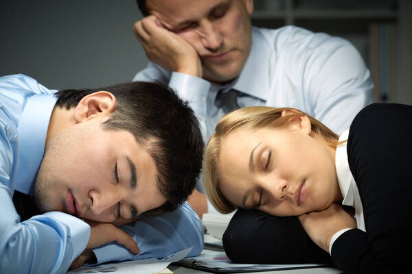 Business people falling asleep at work  