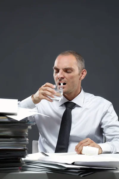 Manager taking medicine at workplace — Stock Photo, Image