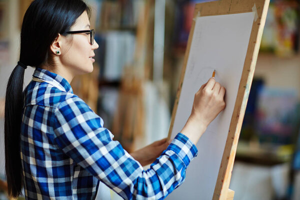 girl drawing sketch on paper sheet
