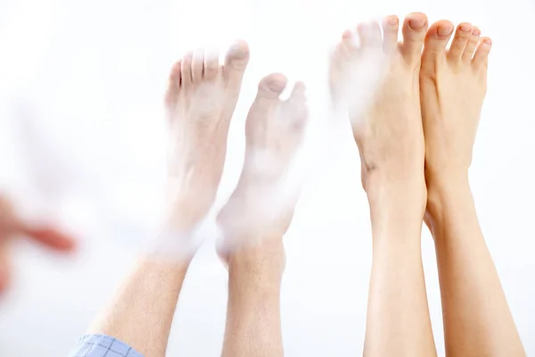 Raised male and female legs — Stock Photo, Image