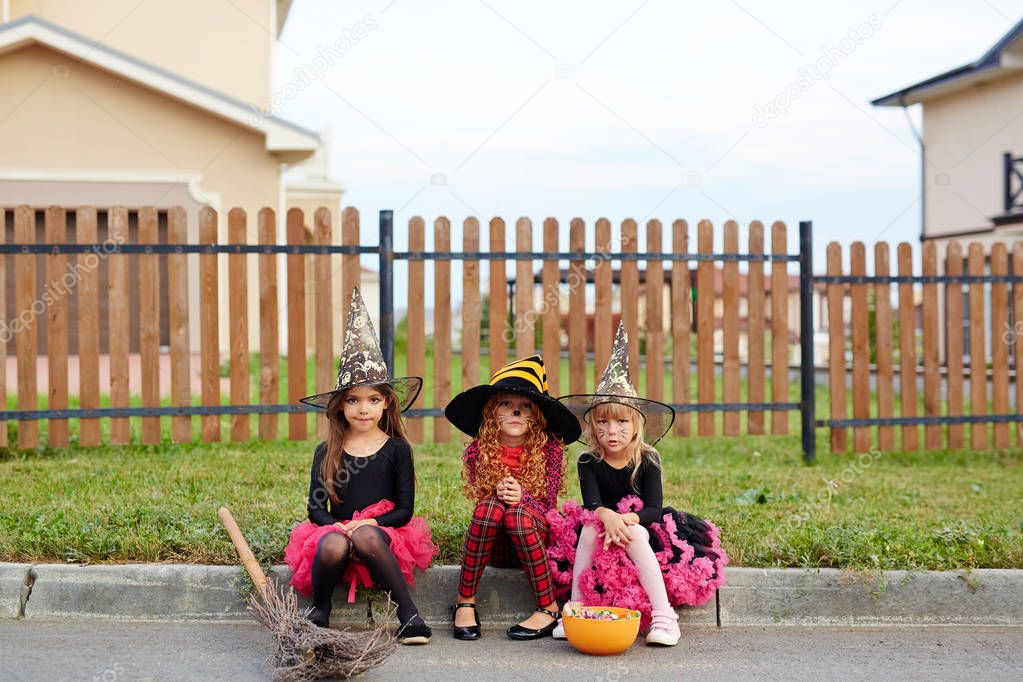 Three gloomy girls in Halloween attire 