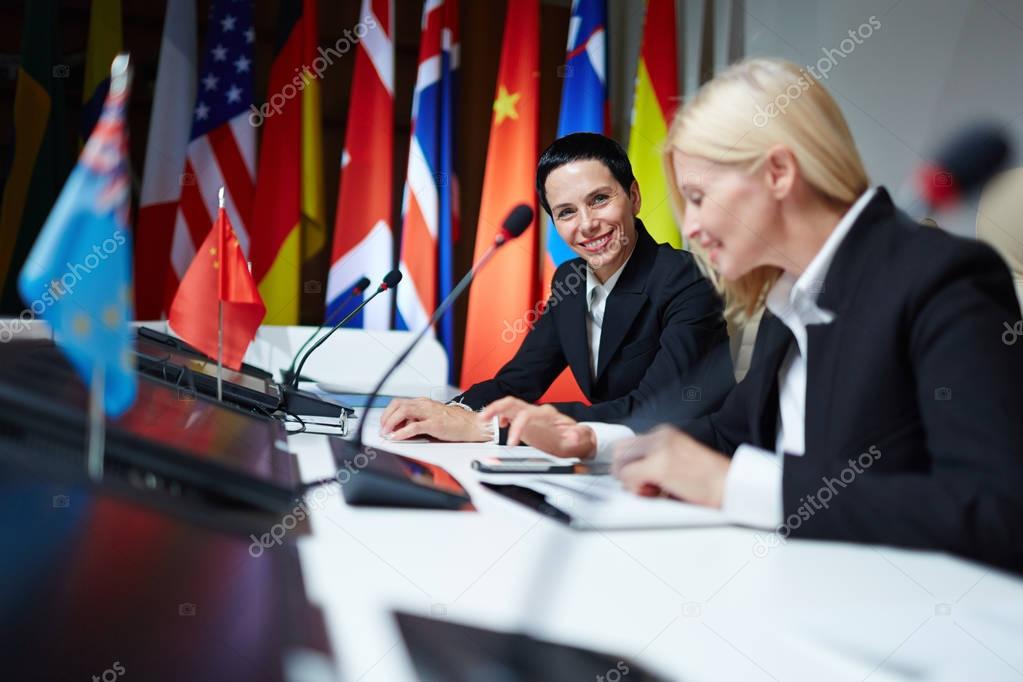 female politicians looking at camera at conference