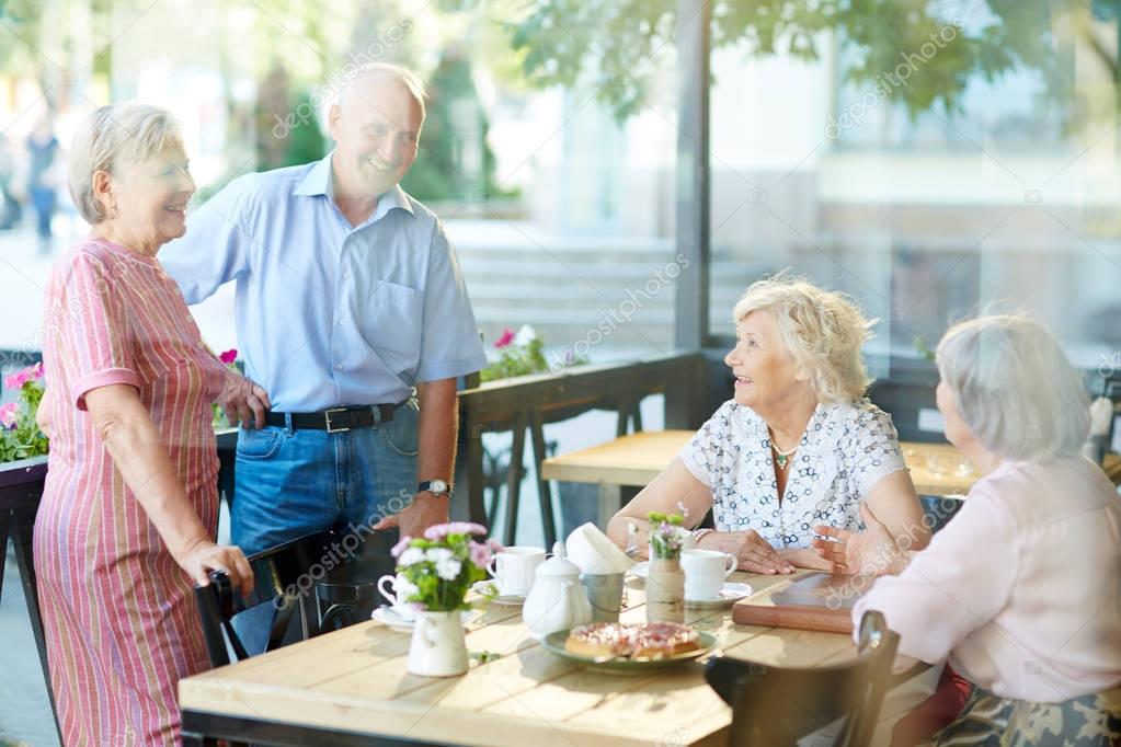 senior friends having nice time in cafe 