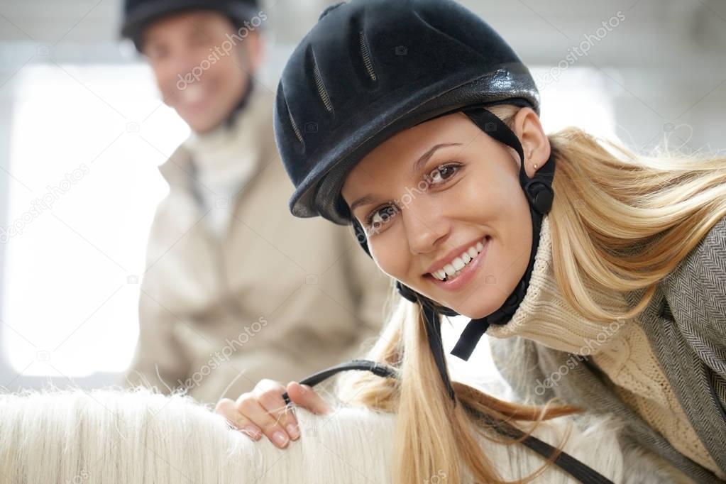 woman sitting on horseback 