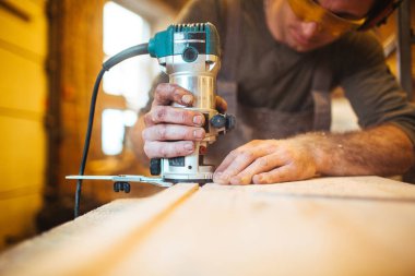 handyman cutting wooden board