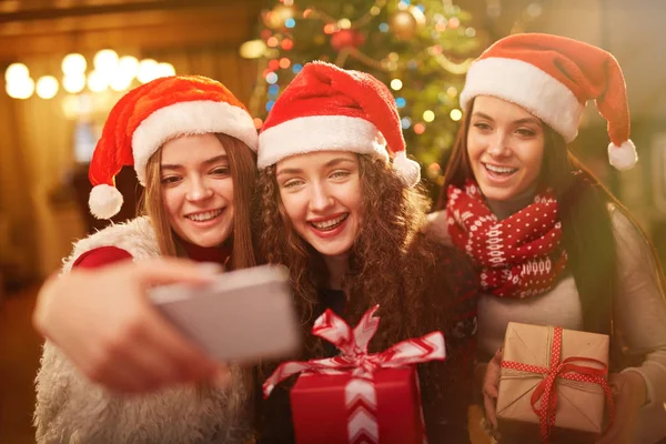 Joyful girls making Christmas selfie — Stock Photo, Image